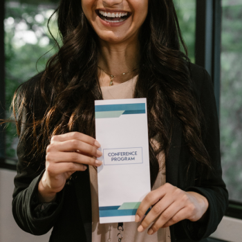 Woman Holding Sponsored Program Guide