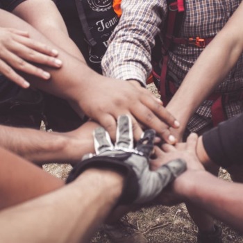 Many volunteers with hands crossed